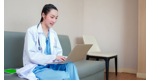 a doctor working on a laptop