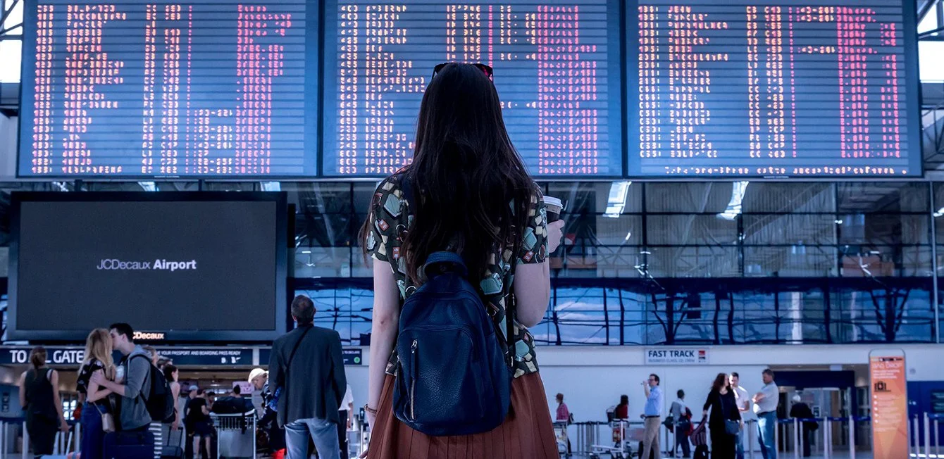 a person walking in a large room with large screens
